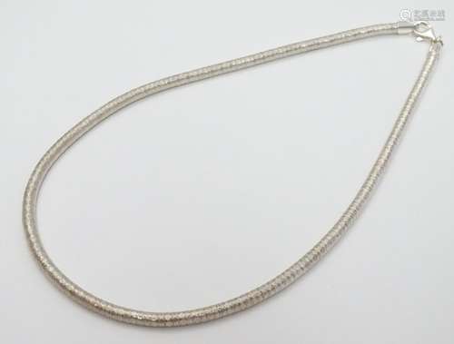 A silver necklace of slinky choker style. Approx 16