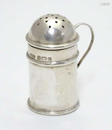 A silver pepperette formed as a flour shaker with loop handle. Hallmarked Birmingham 1902 maker