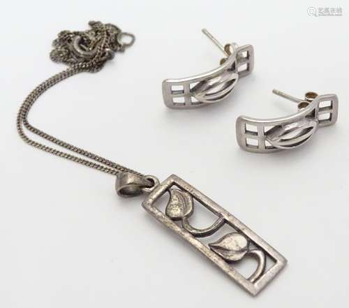 A pair of silver stud earrings together with a silver pendant and chain both inspired by the designs