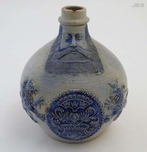 A 19thC German Bellarmine / Bartmann jug with bearded man to the neck and a coat of arms with