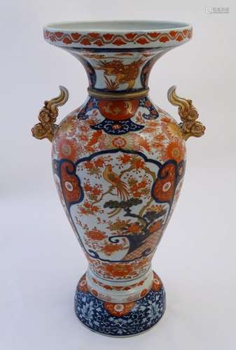 A large Oriental baluster vase with a flared rim and twin handles formed as stylised clouds.