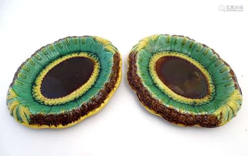 A pair of Victorian majolica bread plates, the inner rim decorated with wheat sheaves, the outer