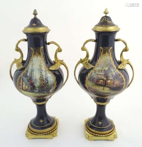 A matched pair of Sevres style lidded urn garnitures on mounted bases, with cobalt blue bodies