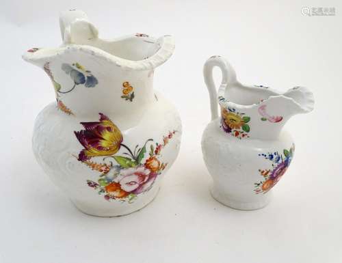 Two 19thC jugs with relief floral decoration and hand painted flowers. Tallest approx. 6 3/4