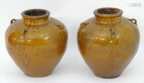 A pair of large Chinese earthenware salt glaze vases with applied handles and incised decoration