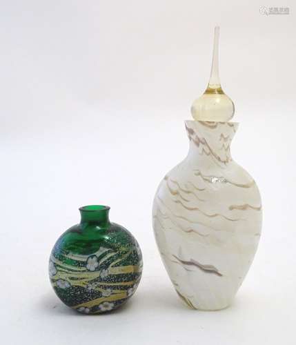 An early 20thC art glass scent bottle, with waved marbled decoration, together with a squat scent