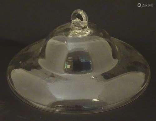 A 19thC clear glass smoke bell, of domed form with looped handle. 10