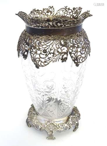 A rock crystal vase of lobed baluster form with cut floral decoration with associated silver