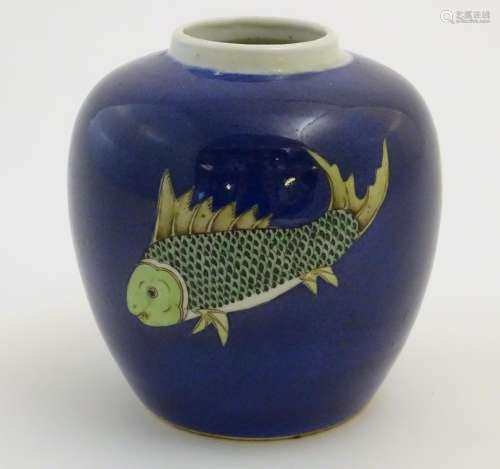 A Chinese vase with a cobalt blue ground decorated with three hand painted fish. Approx. 5 1/2