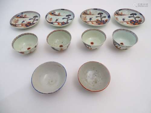 Four Oriental tea bowls and saucers in the Imari palette, decorated with a landscape scene with an