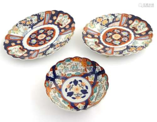 Two Imari dishes of oval form with lobed rims, decorated with panelled flowers and landscapes with