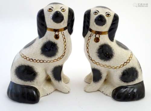 A pair of Staffordshire Ware Kent dogs, formed as spaniels, with gilt highlights. Marked under.