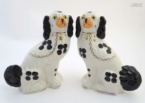 Two pairs of Staffordshire mantel dogs by Arthur Wood, one pair black and white, the other pair