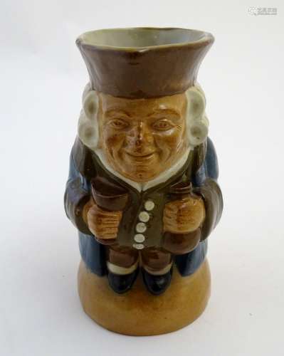 A Royal Doulton Lambeth stoneware Toby character jug, The Standing Man, wearing a brown hat and
