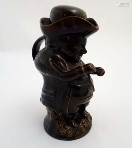 A Victorian Staffordshire treacle glaze Toby character jug, formed as the snuff taker. Approx. 10