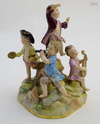 A 19thC Meissen porcelain figure group depicting five putti / children playing musical instruments