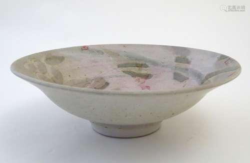 A studio pottery bowl with Oriental inspired decoration depicting stylised lilies and lily pads with