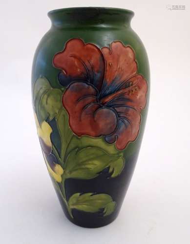 A Moorcroft baluster vase in the hibiscus flower pattern. Impressed and painted marks under. Approx.