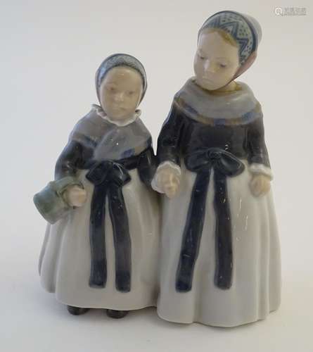 A Royal Copenhagen figure of two Amager girls in traditional dress, model no. 1316, designed by