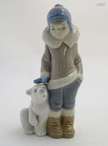 A Lladro figure of a boy with a polar bear cub, model no. 5238. Approx. 5 3/4