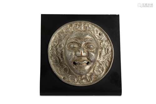 A TIBETAN CIRCULAR SILVERED-COPPER PLAQUE.