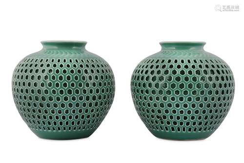 A PAIR OF CHINESE RETICULATED CELADON-GLAZED JARS.