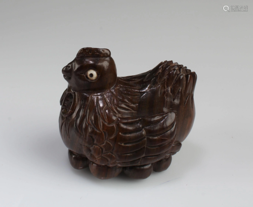A Carved Wooden Hen Figurine