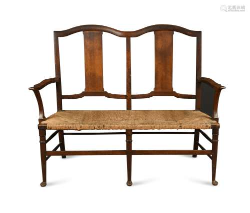 In the manner of Morris & Co., an Arts & Crafts oak settle,