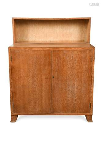 A Heal's limed oak cabinet with bookcase top,