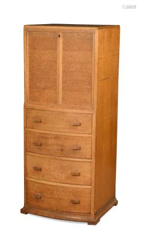 A Heal's style golden oak bow fronted drinks cabinet,