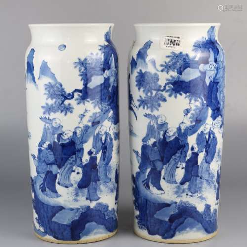 A pair of blue and white figures with landscape patterns
