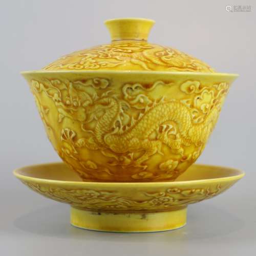 Yellow glazed carved porcelain bowl with dragon pattern