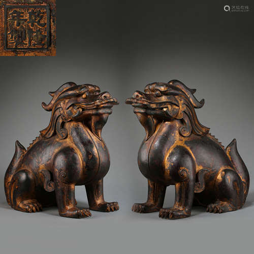 A PAIR OF ANCIENT CHINESE GILT BRONZE BEASTS