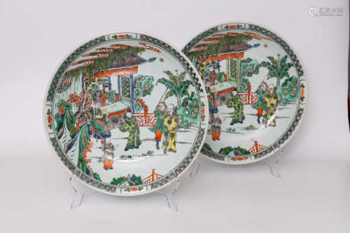 A pair of decorative plates with colorful figures and flowers