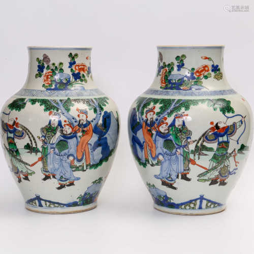 A pair of decorative pots with five colored swords and horses