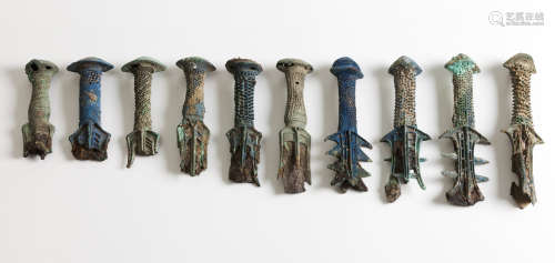 Set of ten sword bronze hilts