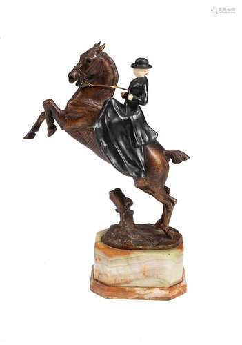 Y After Maximilien Fiot (1866-1953), a patinated bronze, ivory and onyx model of an equestrienne