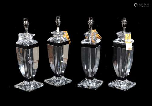 A set of four moulded clear and black glass table lamps