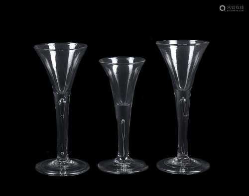 Three plain stemmed wine glasses of drawn trumpet form