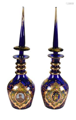 A pair of Turkish blue glass enamelled and gilt large decanters and stoppers printed with portraits