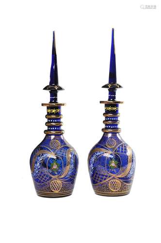 A pair of modern Turkish blue glass, enamelled and gilt large decanters and spire stoppers