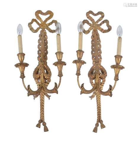 A pair of carved and giltwood twin light wall appliques