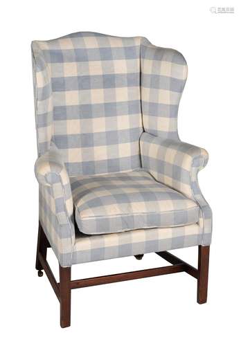 A George III mahogany and upholstered wing armchair