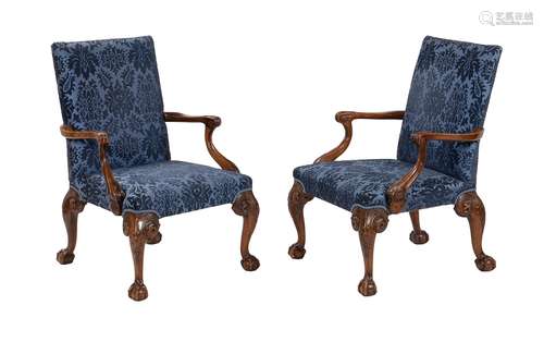 A pair of walnut and upholstered open armchairs