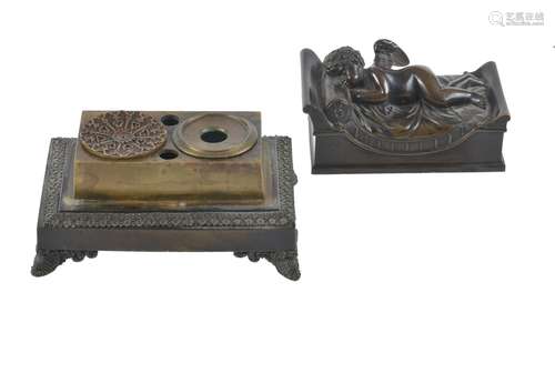 A Charles X patinated bronze figural inkwell modelled with a sleeping Cupid