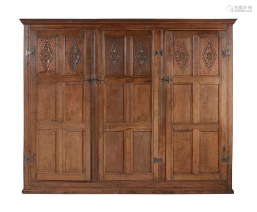 An oak panelled wardrobe in late 17th century style