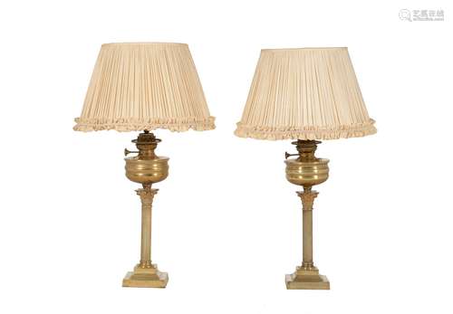 A pair of late Victorian gilt brass table oil lamps