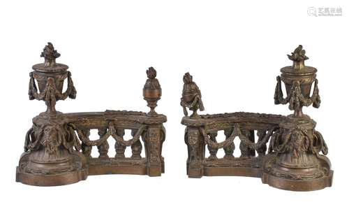 A pair of French patinated metal chenets in Louis XVI taste