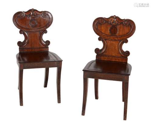 A pair of George IV mahogany hall chairs