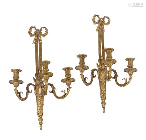 A set of four gilt metal three light wall appliques in Louis XVI style